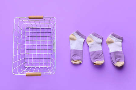 Basket with socks on lilac backgroundの写真素材