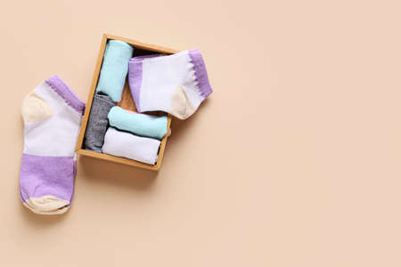 Box with stylish socks on color backgroundの写真素材