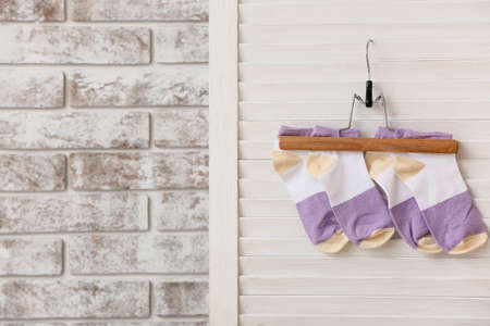 Hanger with stylish socks on folding screen