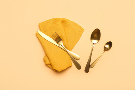 Set of stainless steel cutlery on color backgroundの写真素材