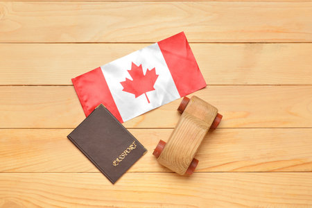 Flag of Canada with passport and car figure on wooden backgroundの写真素材