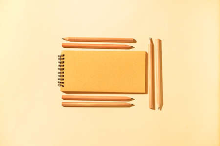 Notebook with pencils on color backgroundの写真素材