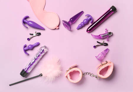 Frame made of toys from sex shop on color backgroundの写真素材