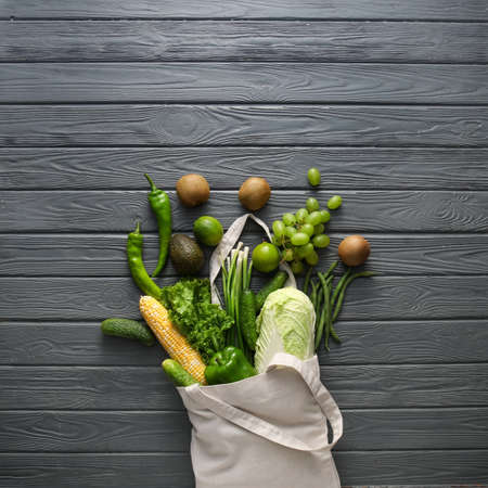 Eco bag with different products on wooden backgroundの写真素材