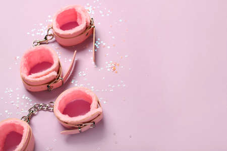 Handcuffs from sex shop on color backgroundの写真素材