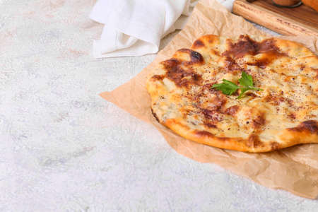 Parchment with tasty khachapuri on light backgroundの写真素材
