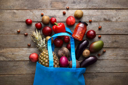 Eco bag with different products on wooden backgroundの写真素材