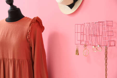 Decor in shape of word LOVE with stylish accessories and mannequin with dress near color wallの写真素材