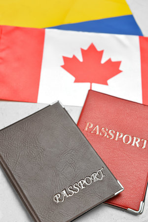 Flags of Canada and Ukraine with passports on white backgroundの写真素材