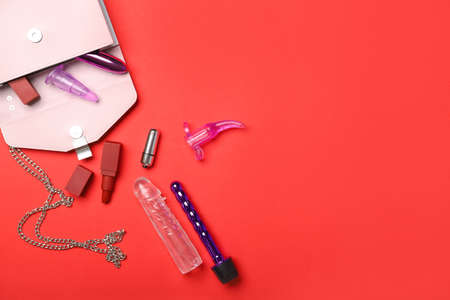 Sex toys, bag and cosmetics on color backgroundの写真素材