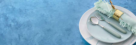 Elegant table setting on blue background with space for text