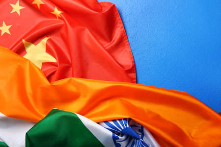 Flags of China and India on color background