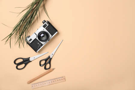 Composition with stationery and photo camera on color background
