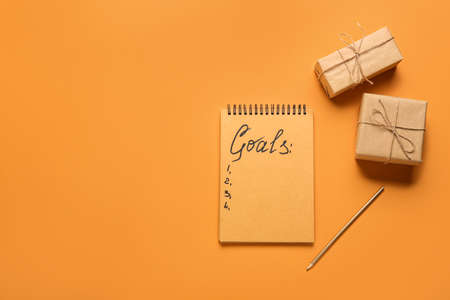 Empty to do list and gifts on color background. new year goals