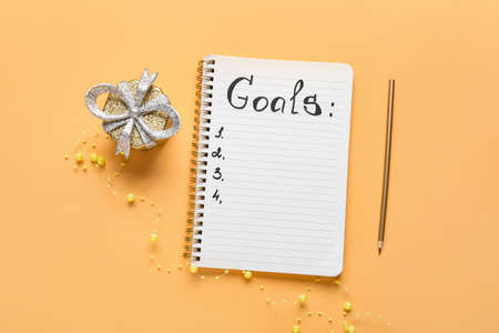 Empty to do list and gift on color background. new year goalsの写真素材