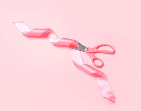 Scissors and ribbon on color backgroundの写真素材