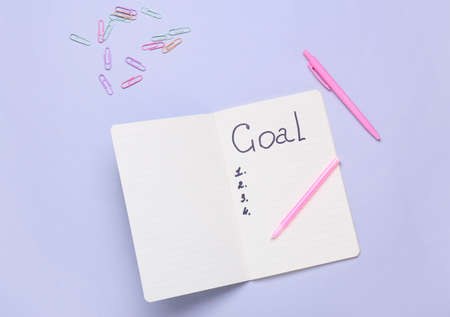 Notebook with empty to do list and stationery on gray background. new year goalsの写真素材