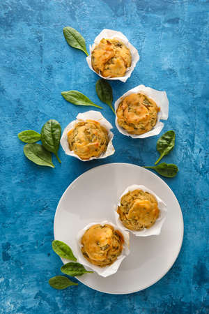 Composition with tasty spinach muffins on color backgroundの写真素材