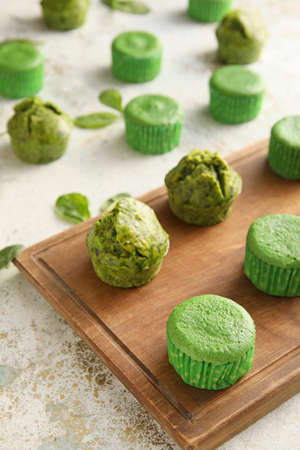Composition with tasty spinach muffins on light backgroundの写真素材