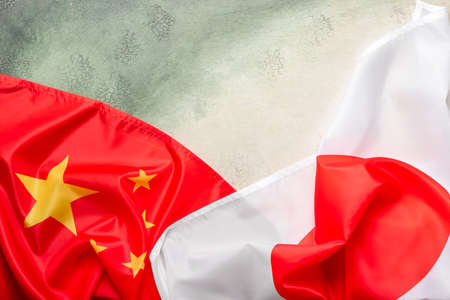 Flags of China and Japan on grunge backgroundの写真素材