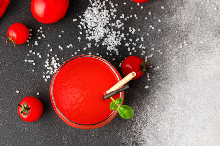 Glass of tasty tomato juice on gray backgroundの写真素材