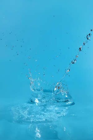 splash of water on blue backgroundの写真素材