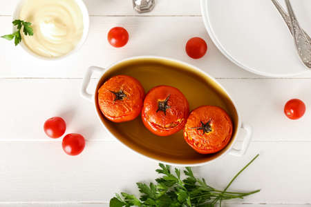 Composition with tasty stuffed tomatoes on light wooden backgroundの写真素材