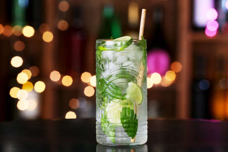 Glass of tasty mojito on table in barの写真素材