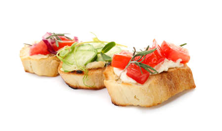 Tasty different bruschettas with vegetables on white backgroundの写真素材