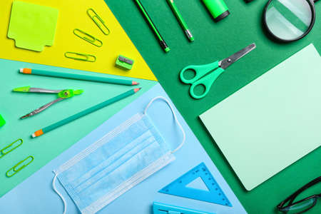 Set of stationery and medical mask on color backgroundの写真素材