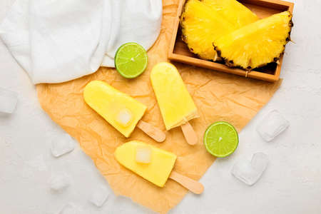 Tasty pineapple ice creams on light background