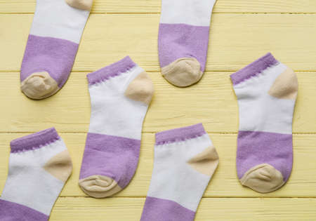 Many socks on yellow wooden background, closeupの写真素材