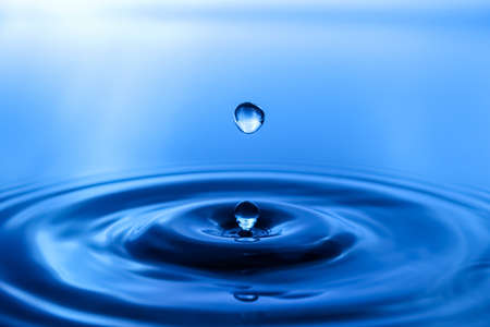 splash of water on blue backgroundの写真素材