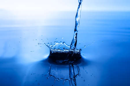 splash of water on blue backgroundの写真素材