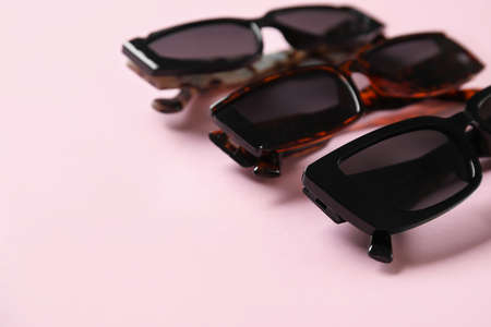 Stylish female sunglasses on color background, closeupの写真素材