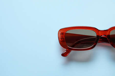 Stylish female sunglasses on color backgroundの写真素材