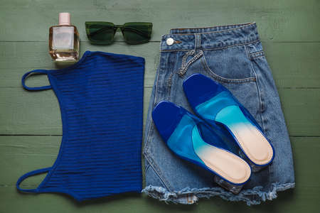 Stylish female clothes, shoes and accessories on color wooden backgroundの写真素材