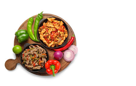 Frying pans with delicious Fajita and vegetables on white backgroundの写真素材