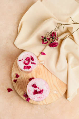 Cups of tasty rose latte on grunge backgroundの写真素材