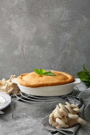 Baking dish with tasty mushroom pot pie on grunge backgroundの写真素材