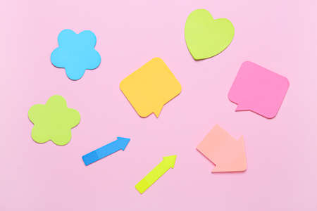 Different sticky note papers on pink background