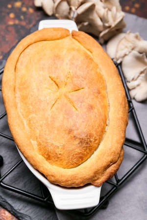 Baking dish with tasty mushroom pot pie on tableの写真素材