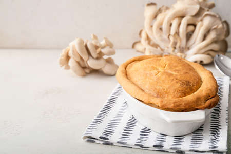 Baking dish with tasty mushroom pot pie on light backgroundの写真素材