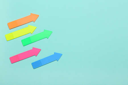 Sticky notes in shape of arrows on blue backgroundの写真素材