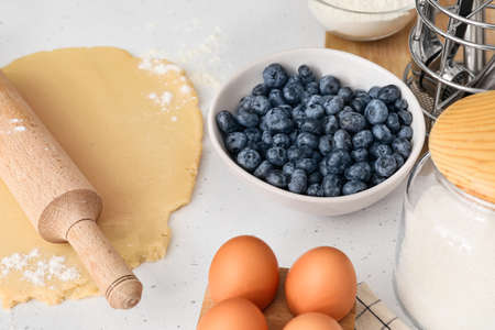 Raw dough with ingredients for blueberry galette on light background, closeupの写真素材