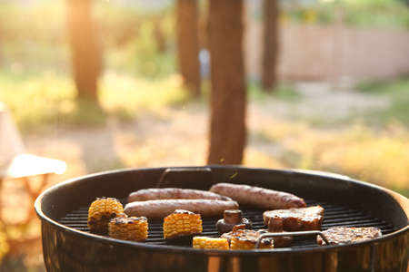 Modern barbecue grill with tasty food outdoorsの写真素材