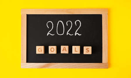 Board with figure 2022 and word GOALS on yellow background