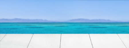 Empty wooden surface against blue sea and skyの写真素材