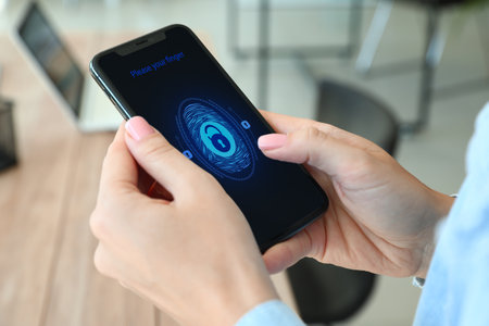 Woman holding smartphone with locked screen, closeupの写真素材