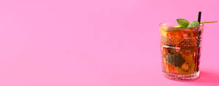 Glass of tasty fruit iced tea on color background with space for textの写真素材